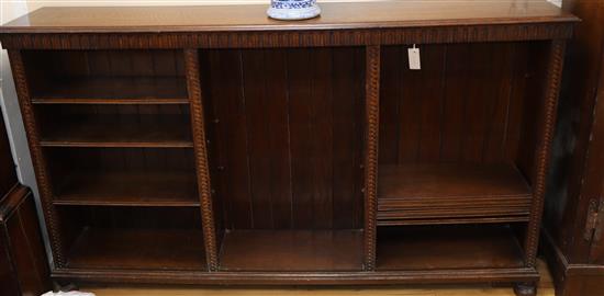 A Waring & Gillow long oak dwarf open bookcase W.184cm